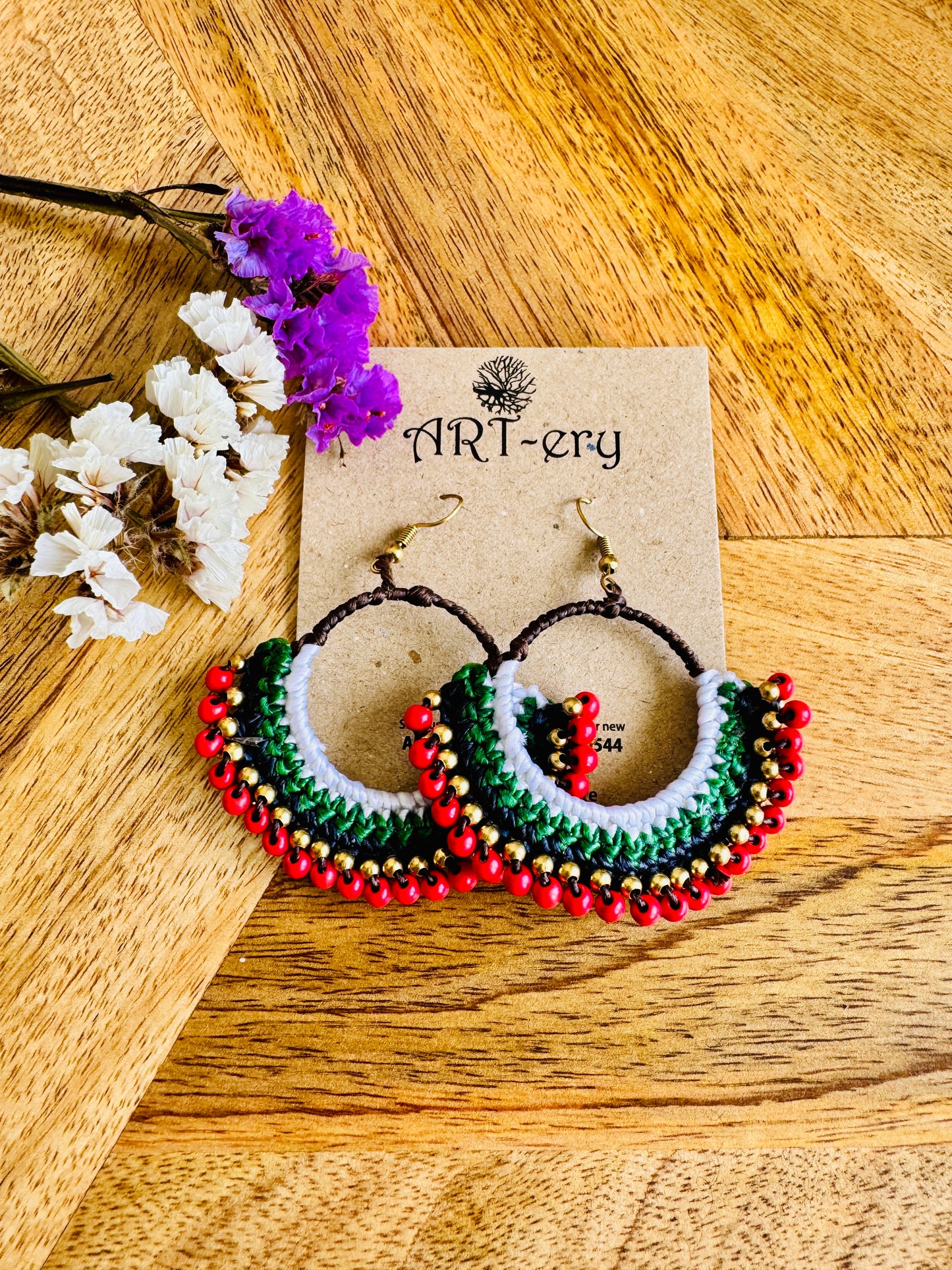 Red beaded crochet earring with green detailing